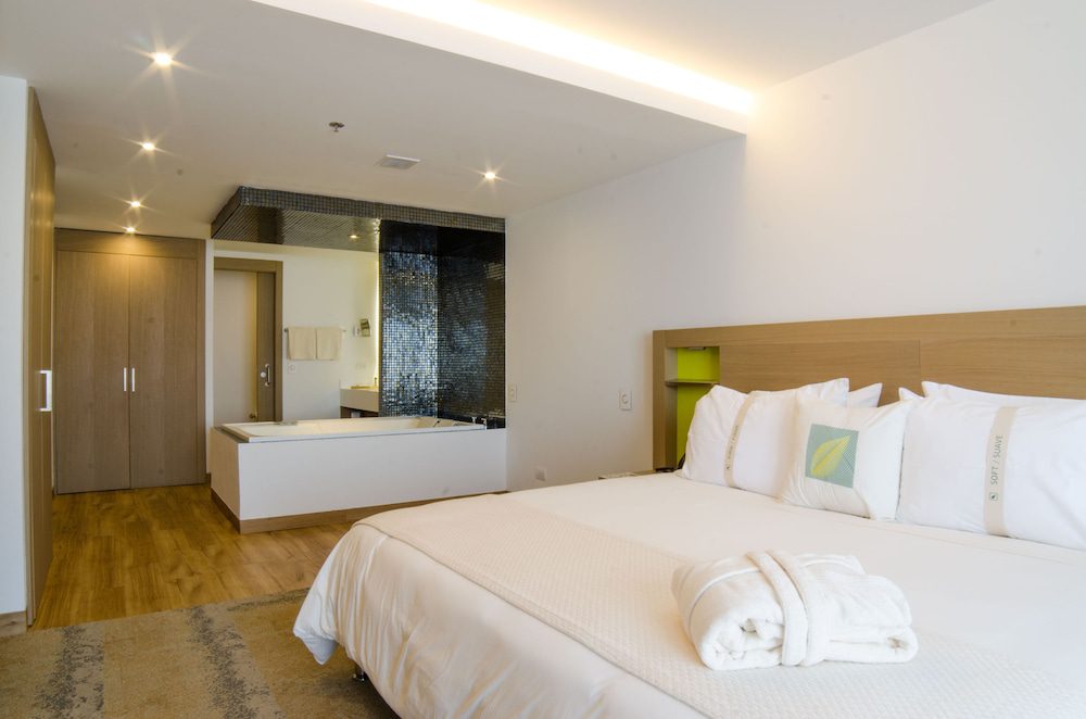Habitación con cama y bañera del Biohotel Organic Suites