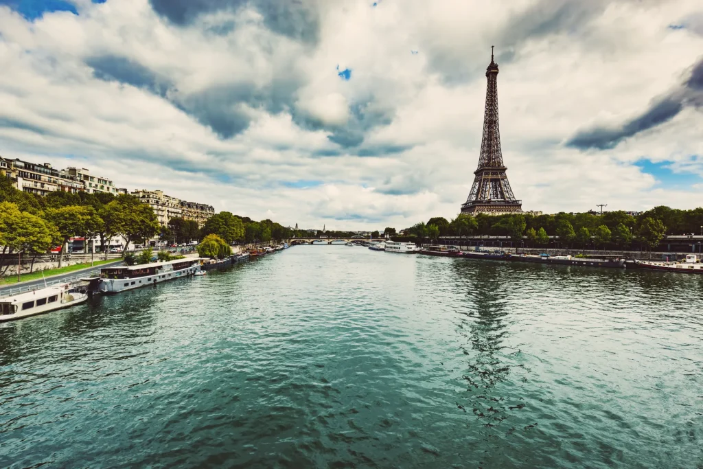 Torre Eiffel junto al río Sena con barcos en la orilla, París, Francia