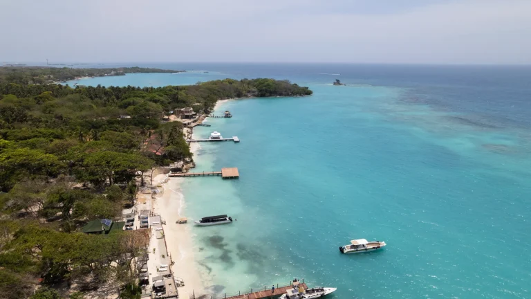 Vista aérea de isla caribeña colombiana con aguas turquesa y lanchas, similar a San Andrés, Colombia